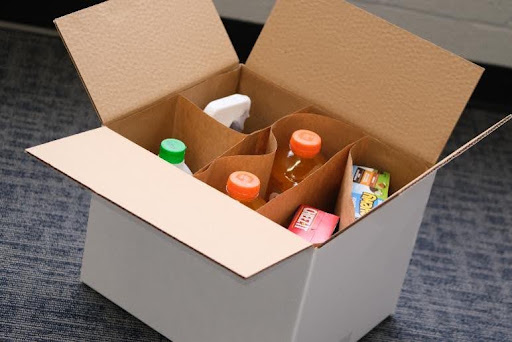 Product carton protected inside a corrugated shipping box with inserts
